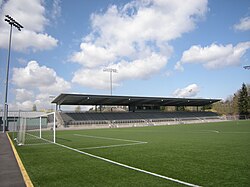 A soccer field with a single-tier grandstand