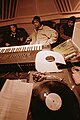 Image 11Hip hop producer and rapper RZA in a music studio with two collaborators. Pictured in the foreground is a synthesizer keyboard and a number of vinyl records; both of these items are key tools that producers and DJs use to create hip hop beats. (from Hip hop production)