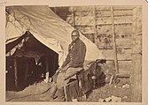 Photograph taken about 1862 of a contraband servant named John Henry in a Union Army Camp.[17]