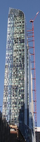 Southern facade as seen from West 57th Street with setbacks resembling a waterfall, and western facade with tall windows in random shades of blue, gray, or simply black, reminiscent of Gustav Klimt's paintings with similar colors and patterns, such as The Kiss