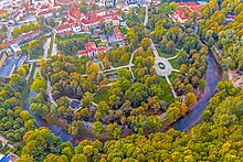 Aerial view of a large green area with many trees