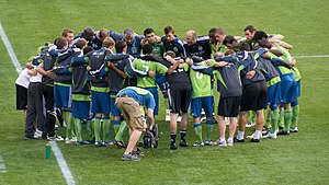 A group of players on a grass pitch