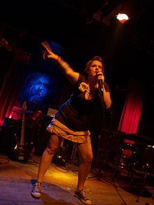 Photograph of a woman holding a microphone