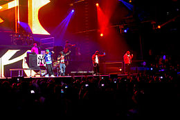 Gudda Gudda (far right) performing with Mack Maine, Lil Wayne, and Jae Millz at a concert at the General Motors Place in Vancouver.