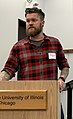 Image 115American man wearing a slim-fitting flannel shirt, a beard, and an undercut, 2019. Sleeve tattoos can be seen. (from 2010s in fashion)