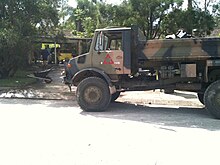 Photograph of a large truck in front of a house