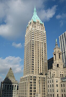 40 Wall Street as seen in December 2005. The building has a masonry facade with narrow vertical bays of windows. There is a green pyramidal roof at the top.