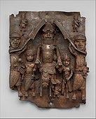 Plaque equestrian an Oba on horseback with attendants; between 1550 and 1680; brass; height: 49.5 cm (197⁄16 in.), width: 41.9 (161⁄2 in.), diameter: 11.4 cm (41⁄2 in.); Metropolitan Museum of Art