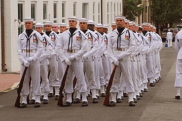 Enlisted Full Dress Whites worn at a Change of Command Ceremony in 2009. This is the older-style version that was replaced in 2021; it lacks the blue piping and stars