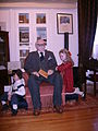 Figure of a grandfather reading fairy tales to his grandchildren. Drossinis loved children and wrote fairy tales, always with educational content (‘Folk’ Hall).