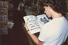 Man reading a book in a store