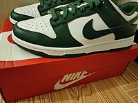 A green pair of Nike Dunk sneakers