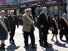 A group of smiling people marching