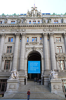 Main entrance archway of the Custom House as seen in 2013. There is a banner for the Museum of the American Indian in the archway.