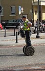 A police officer on a motorized scooter