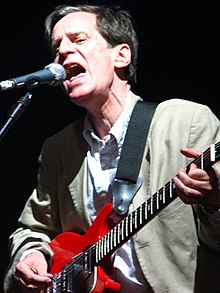 Chilton singing and playing the guitar