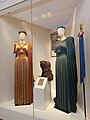 Maria Callas' opera costumes from the 1960 Norma (costumes to the left and right) and the 1961 Medea (wig at the center), both in the ancient theatre of Epidaurus, and from the 1954 Tosca in Genoa (thyrsus-like walking stick, right).