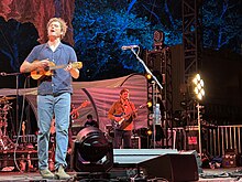 Vance Joy playing live music.