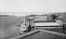 Photo taken from a rooftop of the ferry at the dock, with the bridge in the background