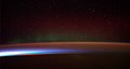 Image 82Earth's night-side upper atmosphere appearing from the bottom as bands of afterglow illuminating the troposphere in orange with silhouettes of clouds, and the stratosphere in white and blue. Next the mesosphere (pink area) extends to the orange and faintly green line of the lowest airglow, at about one hundred kilometers at the edge of space and the lower edge of the thermosphere (invisible). Continuing with green and red bands of aurorae stretching over several hundred kilometers. (from Earth)