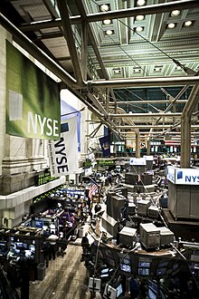 Photograph of the main trading floor crowded with work desks and computer screens