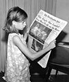 Image 44A girl reading a 21 July 1969 copy of The Washington Post reporting on the Apollo 11 Moon landing (from Newspaper)