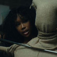 Cover art of "Kill Bill": SZA behind a training dummy, holding a katana towards its neck