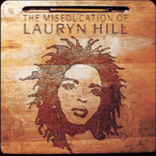 The album title and Lauryn Hill's head are etched on a wooden desk, also holding a pencil in a groove at the top.