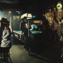 A group of people playing billiards