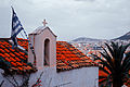Sky blue-white (Flag of Greece) on a church rooftop against background of Athens cityscape. Athens, Greece.