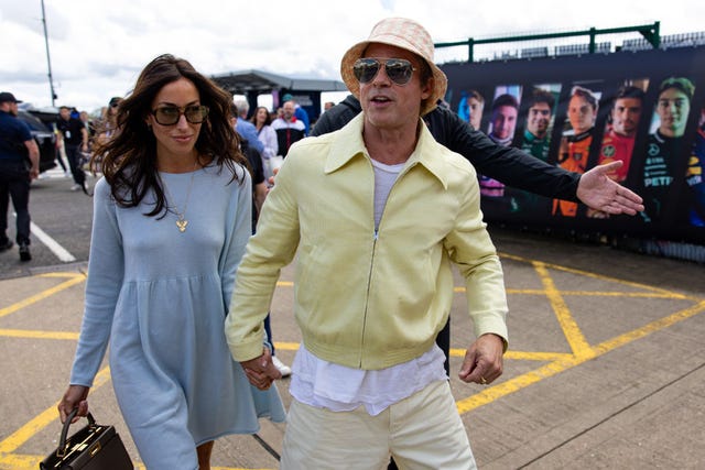 Actor Brad Pitt and girlfriend Ines De Ramon walk in the paddock during the F1 Grand Prix of Great Britain at Silverstone Circuit on July 7, 2024 in Northampton, United Kingdom