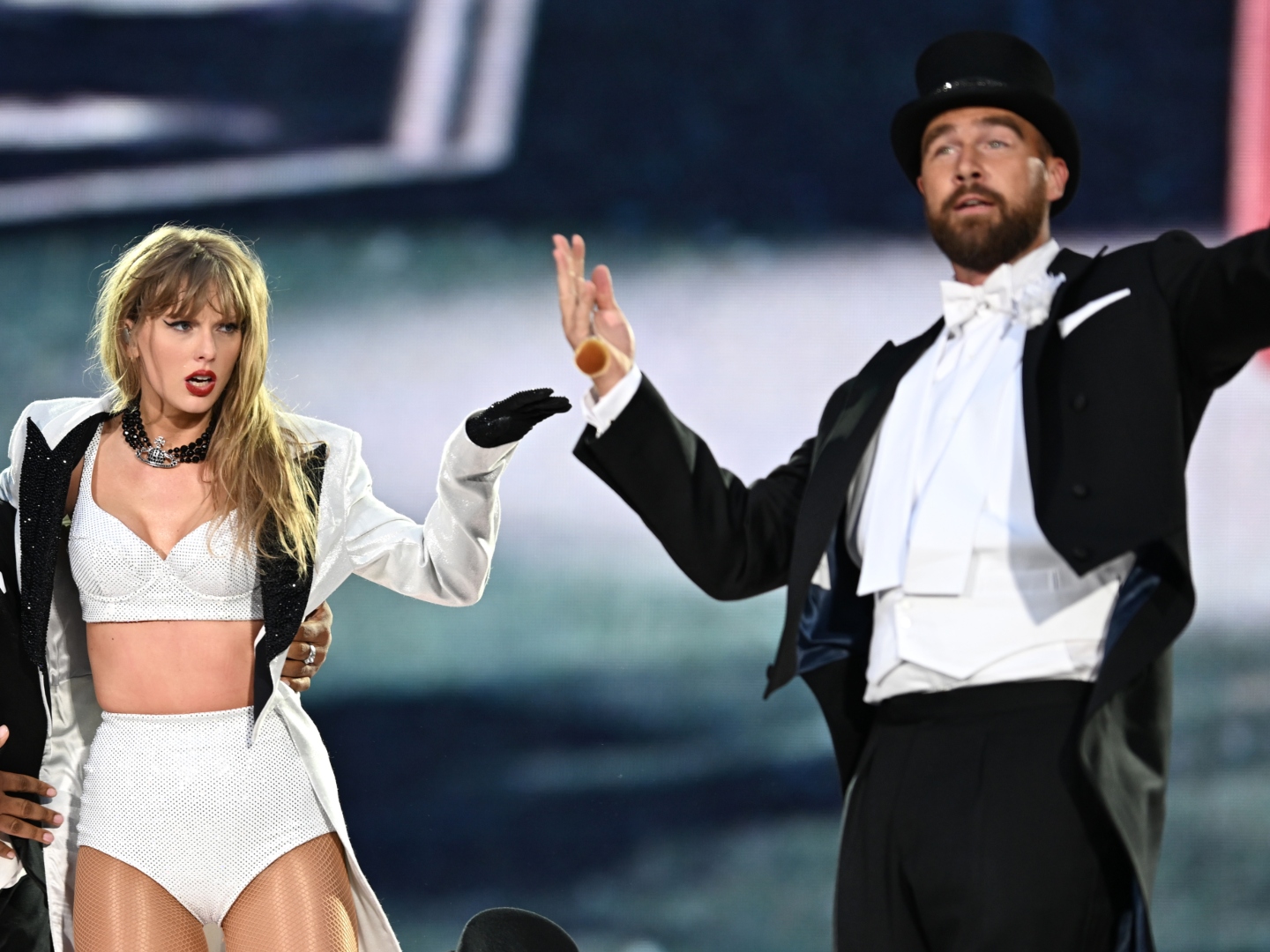 Taylor Swift is joined on stage by Travis Kelce (R), during "Taylor Swift | The Eras Tour" at Wembley Stadium on June 23, 2024 in London, England.