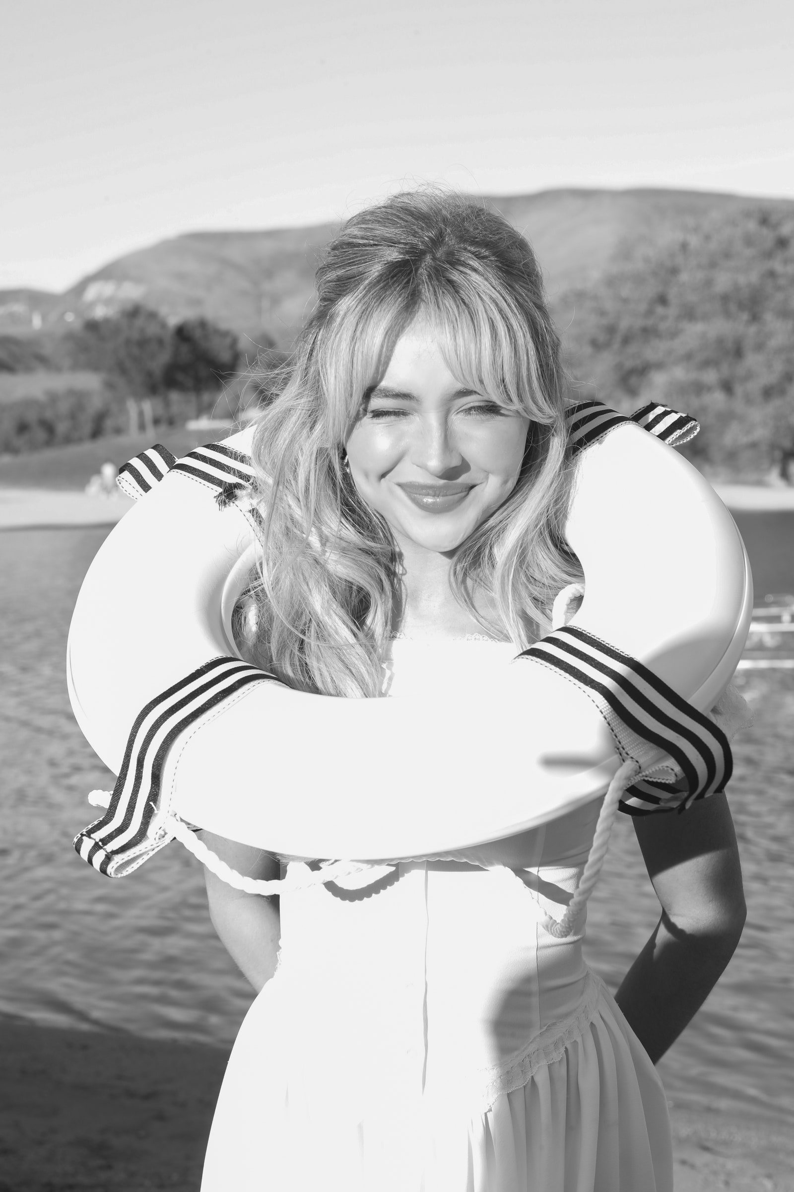 Image may contain Sabrina Carpenter Face Head Person Photography Portrait Water Adult Clothing Swimwear and Happy