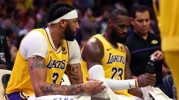 Apr 12, 2024; Memphis, Tennessee, USA; Los Angeles Lakers forward Anthony Davis (3) and forward LeBron James (23) sit on the bench during a time out during the second half against the Memphis Grizzlies at FedExForum.