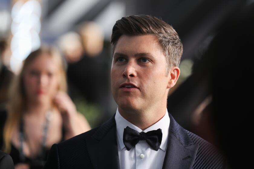 Colin Jost in a tuxedo at the Screen Actors Guild Awards tilting his chin up as he speaks