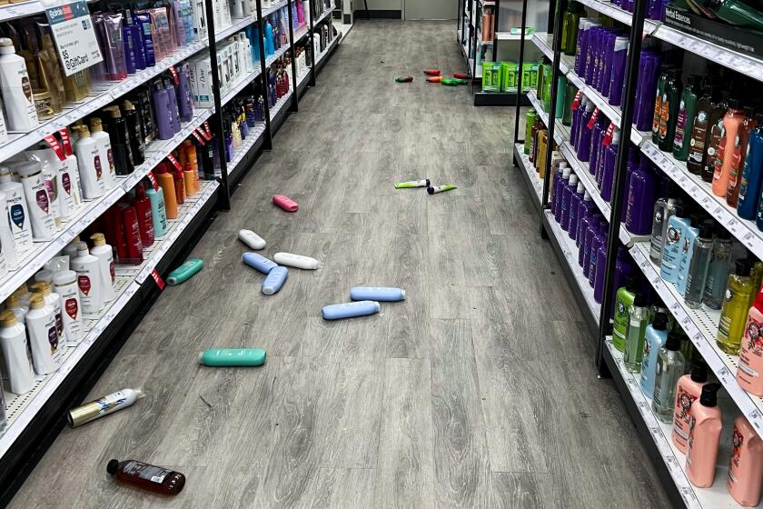  Signs fell off shelves of the grocery department and bottles of shampoo were on the ground 