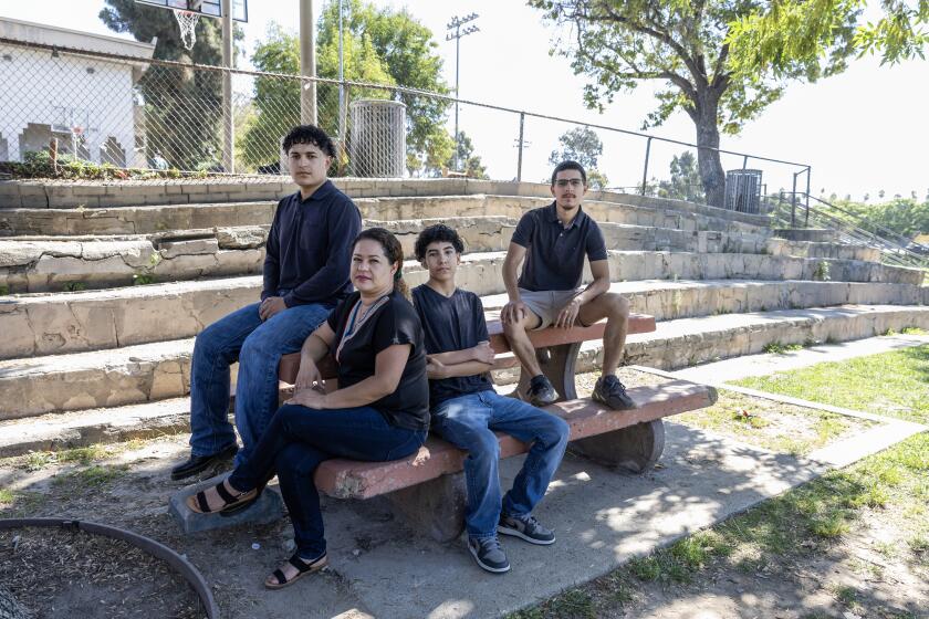 LOS ANGELES, CA - AUGUST 03: Celenia Gutierrez and her children Anthony Sanchez, 19, left, Brandon Sanchez, 13 and Christopher Sanchez, 24, are cautiously hopeful about being reunited with her husband and their father Isaias Sanchez Gonzalez under President Joe Biden's immigration order. Photographed at Ramon Garcia Recreation Center in Los Angeles, CA on Saturday, Aug. 3, 2024. (Myung J. Chun / Los Angeles Times)