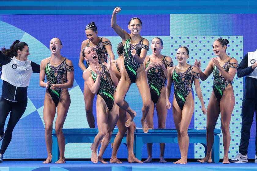 The U.S. artistic swimming team celebrates clinching the silver medal during the 2024 Paris Olympics Wednesday. 