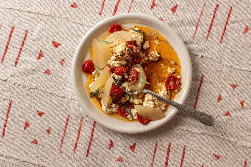 LOS ANGELES, CA - MARCH 25: A dish of marinated feta with grapefruit and roasted tomatoes on Monday, March 25, 2024 in Los Angeles, CA. (Catherine Dzilenski / For The Times)