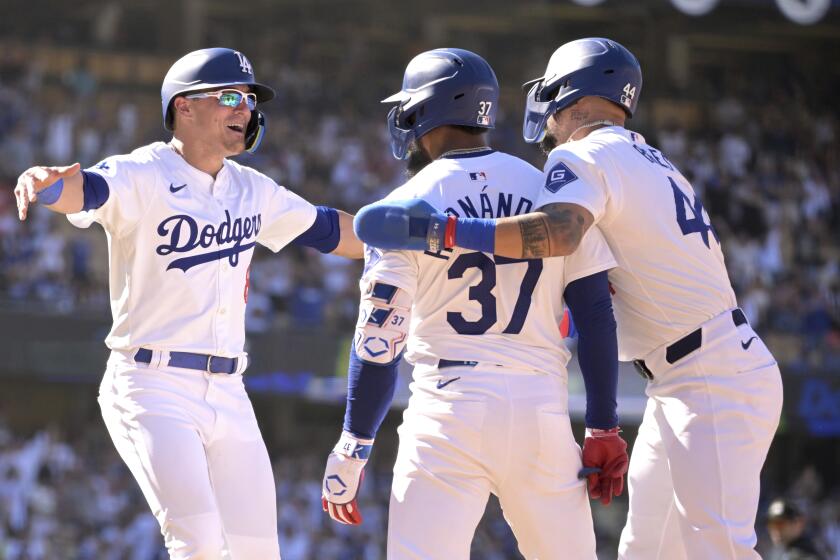 Los Angeles Dodgers' Teoscar Hernandez (37) is congratulated by Enrique Hernandez, left, and Andy Pages after hitting a walk-off single in the tenth inning during a baseball game against the Pittsburgh Pirates Sunday, Aug. 11, 2024, in Los Angeles. (AP Photo/Jayne-Kamin-Oncea)