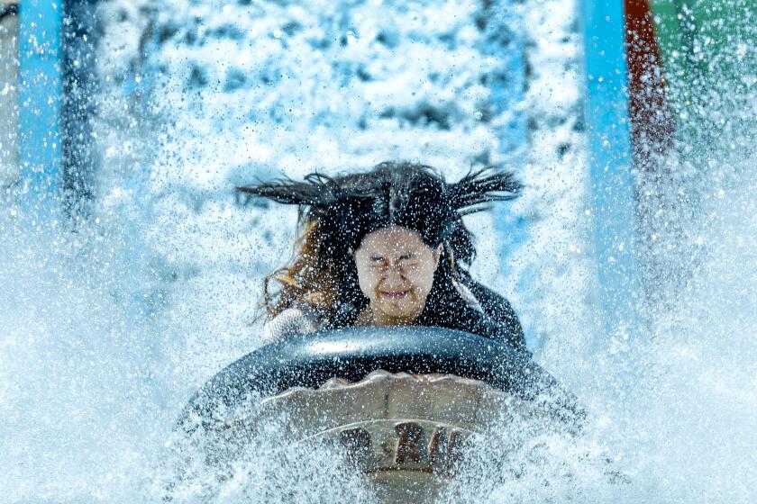 Costa Mesa, CA - August 02: Amid high temperatures, riders cool off as they hit the water on the Wild River ride at the Orange County Fair in Costa Mesa Friday, Aug. 2, 2024. The 2024 OC Fair theme is "Always a Good Time" and runs through Aug. 18th. (Allen J. Schaben / Los Angeles Times)