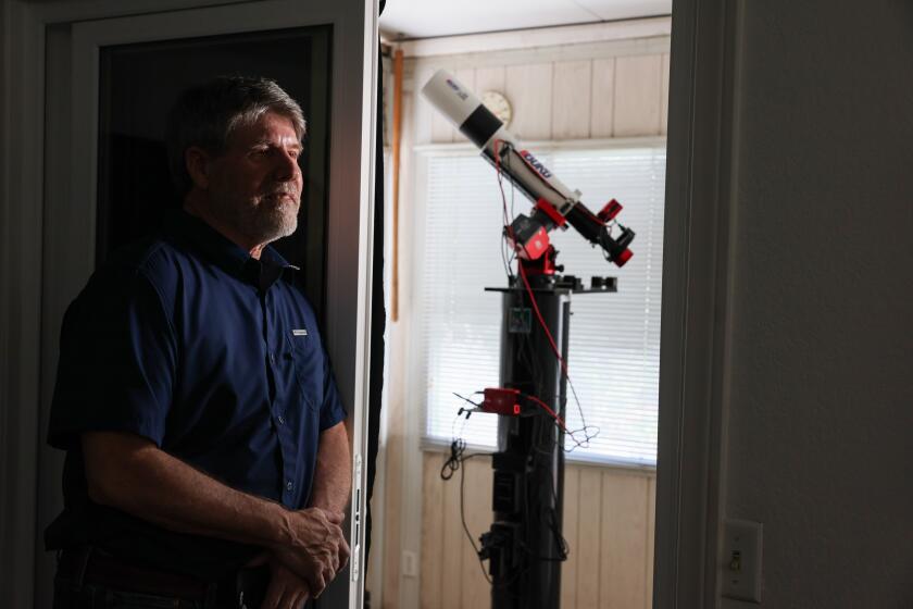 Rancho Cucamonga, CA, Monday, July 22, 2024 - Bob Stephens is an amateur astronomer who mans a backyard telescope that he's using to observe a star that is expected to explode within the next month. Astronomers are expecting a massive explosion a million times brighter than the sun on a nearby sun sometime before August. The explosion will be visible to the naked eye on Earth and enable new science. He is photographed next to an observation room containing a mounted Borg 101. 101mm F/6.3, telescope attached to a ZWO AsI174mm camera. (Robert Gauthier/Los Angeles Times)