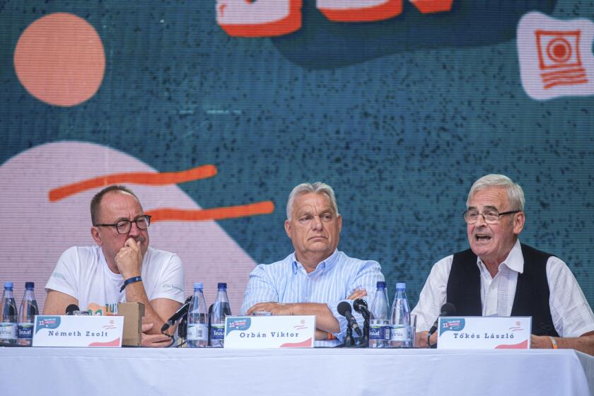 From left: Chairman of the Foreign Committee of the Hungarian Parliament Zsolt Nemeth, Hungarian Prime Minister Viktor Orban and President of the Hungarian National Council of Transylvania Laszlo Tokes attend the 33th Balvanyos Summer University and Students' Camp in Baile Tusnad, Transylvania, Romania, Saturday, July 27, 2024. (Nandor Veres/MTI via AP)/MTI via AP)