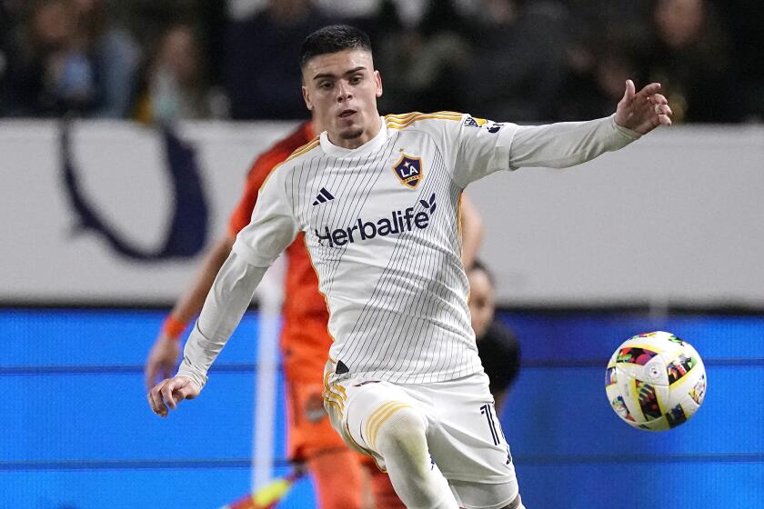 LA Galaxy forward Gabriel Pec, top, is tripped by Houston Dynamo defender Franco Escobar.