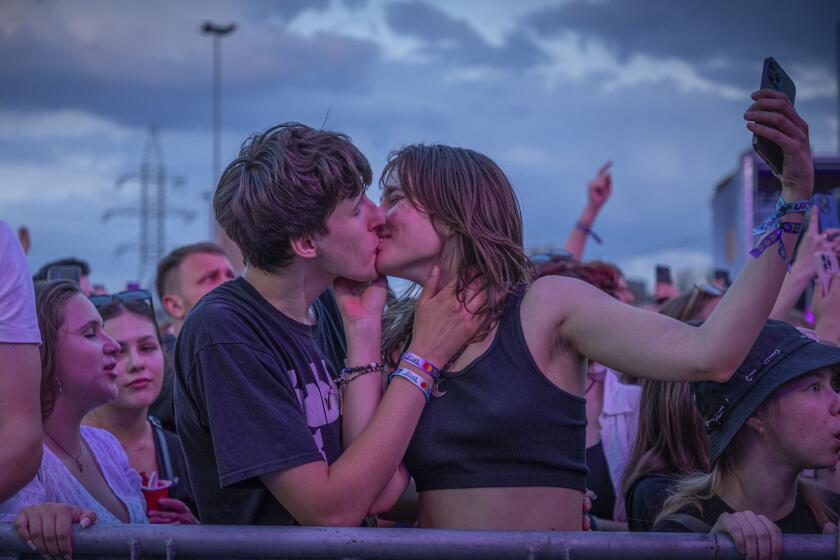 People enjoy a concert at the Atlas Festival in Kyiv, Ukraine, Sunday, July 21, 2024. This year, Ukraine's largest music festival struck a different chord. Gone were the international headliners, the massive performance halls and the hundreds of thousands of visitors. (AP Photo/Anton Shtuka)