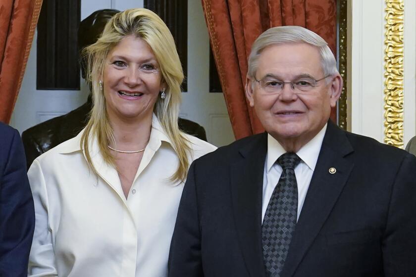 FILE - Senate Foreign Relations Committee Chairman, Sen. Bob Menendez, D-N.J., right, and his wife Nadine Arslanian, pose for a photo on Capitol Hill in Washington, Dec. 20, 2022. U.S. Sen. Bob Menendez of New Jersey and his wife have been indicted on charges of bribery. Federal prosecutors on Friday announced the charges against the 69-year-old Democrat nearly six years after an earlier criminal case against him ended with a deadlocked jury. (AP Photo/Susan Walsh, File)