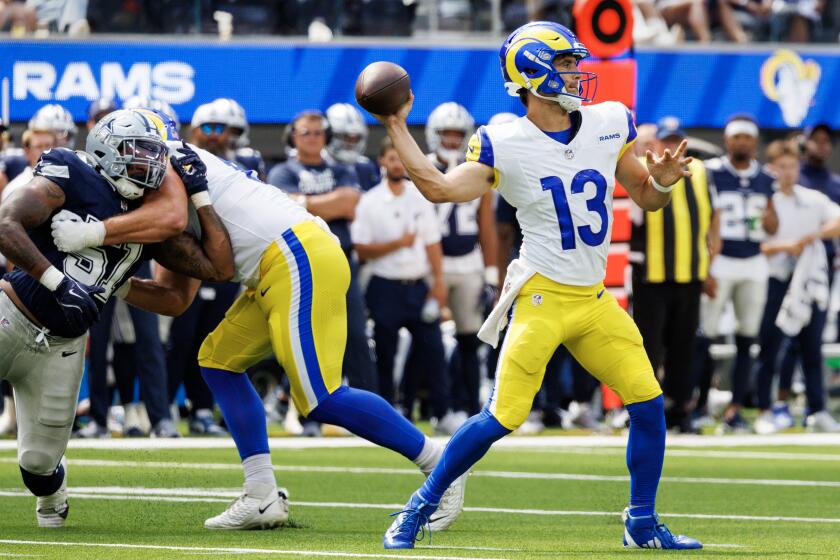 INGLEWOOD, CA - AUGUST 11, 2024: Rams quarterback Stetson Bennett (13) looks for an open receiver against the Dallas Cowboys in the first half of their pre-season game at So-Fi Stadium August 11, 2024 in Inglewood, California. (Gina Ferazzi / Los Angeles Times)