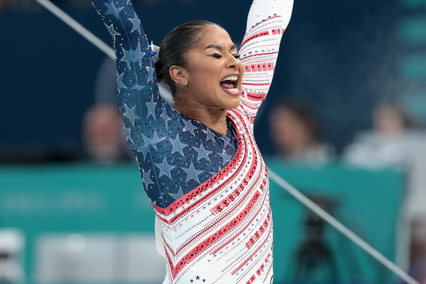 American Jordan Chiles celebrates after completing her uneven bars routine 