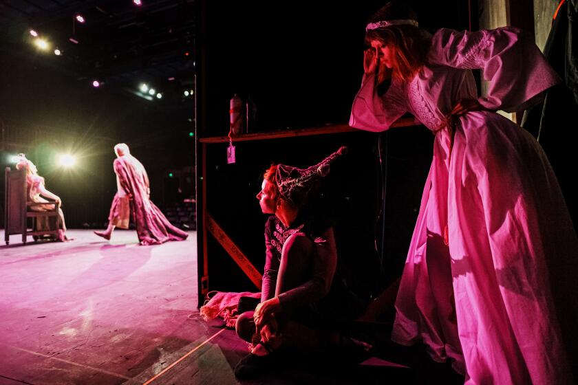 STRATFORD-UPON-AVON, UNITED KINGDOM -- JUNE 14, 2024: Olena Aliabieva, center, and Myroslava Koshtura, far right, wait backstage for their turn to perform during the rehearsal of OKing LearO at the Other Place theater, in Stratford-upon-Avon, United Kingdom, Friday, June 14, 2024. A Ukrainian theater company called UkraineOs Theatre studio of IDPOs Uzhik, from the small city of Uzhorod staged its first production outside Ukraine, traveling to Stratford-upon-Avon, England N birthplace of William Shakespeare N to stage OKing Lear.O The company is made up of war-displaced amateur actors. (MARCUS YAM / LOS ANGELES TIMES)