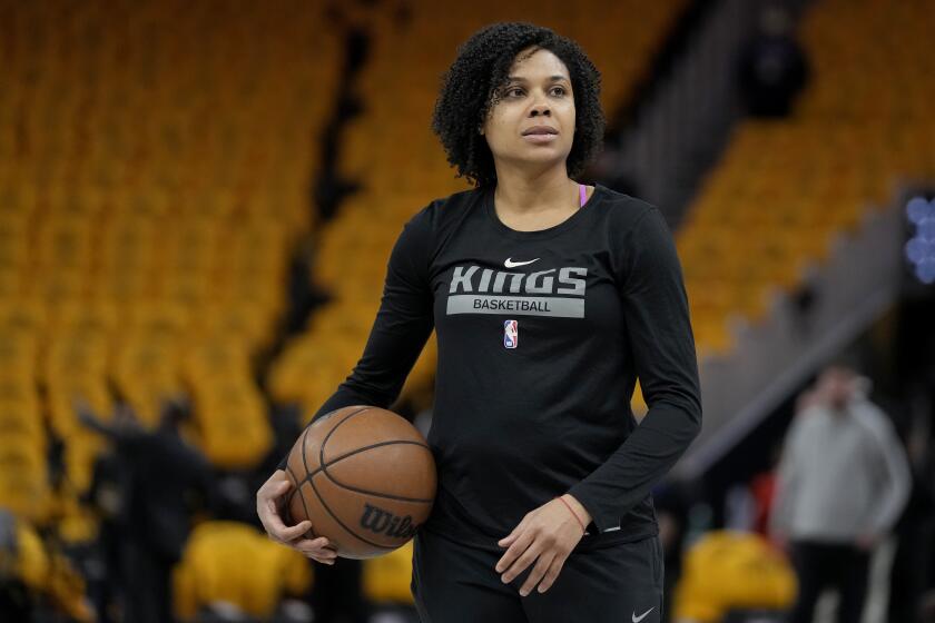 FILE - Sacramento Kings assistant coach Lindsey Harding looks.